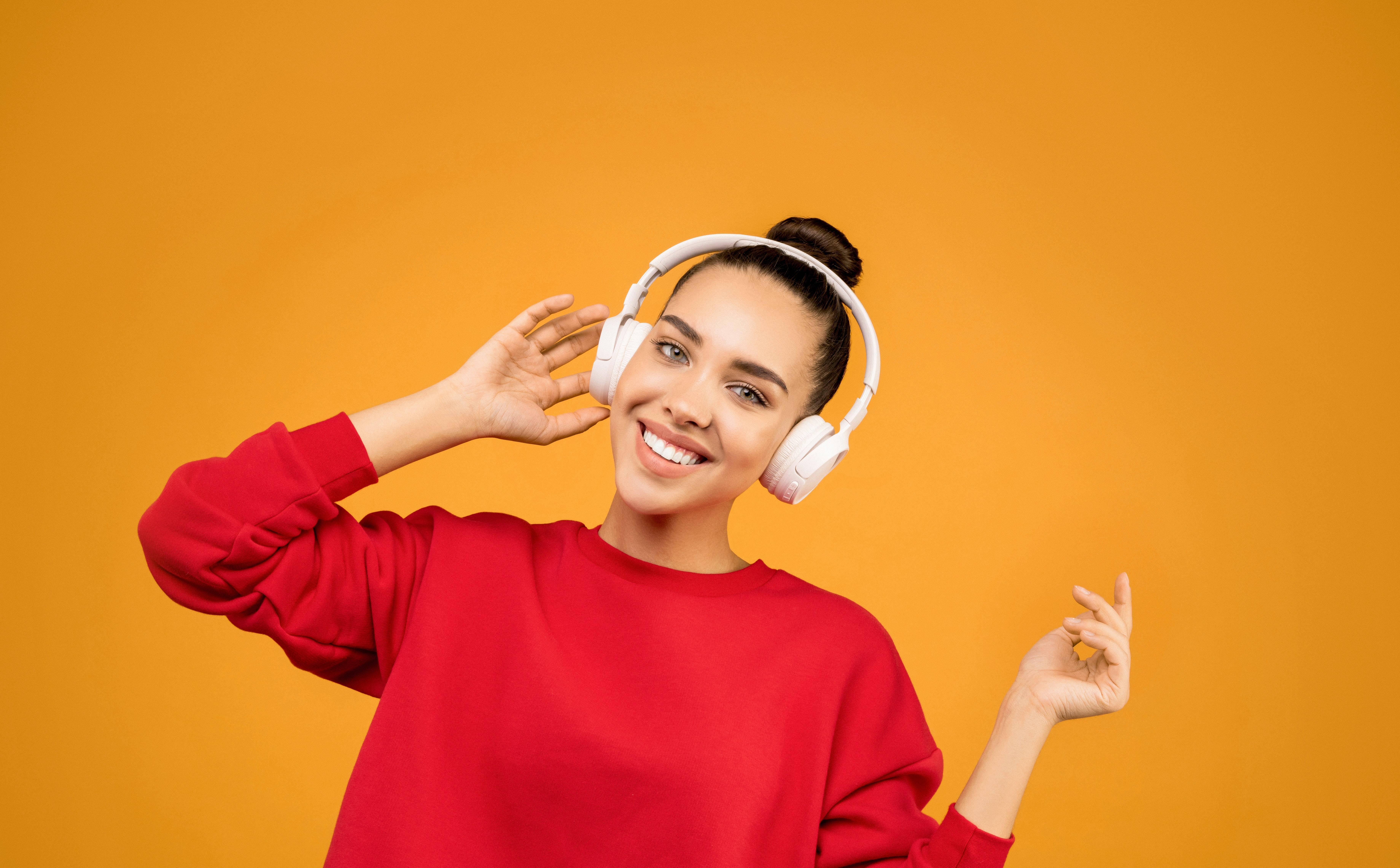 image for royal heir entertainment music promotion tips blog post of a woman listening to music on white headphones